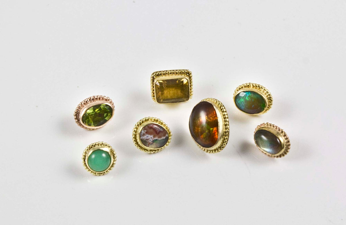 A collection of 14k threadless ends in different color stones.