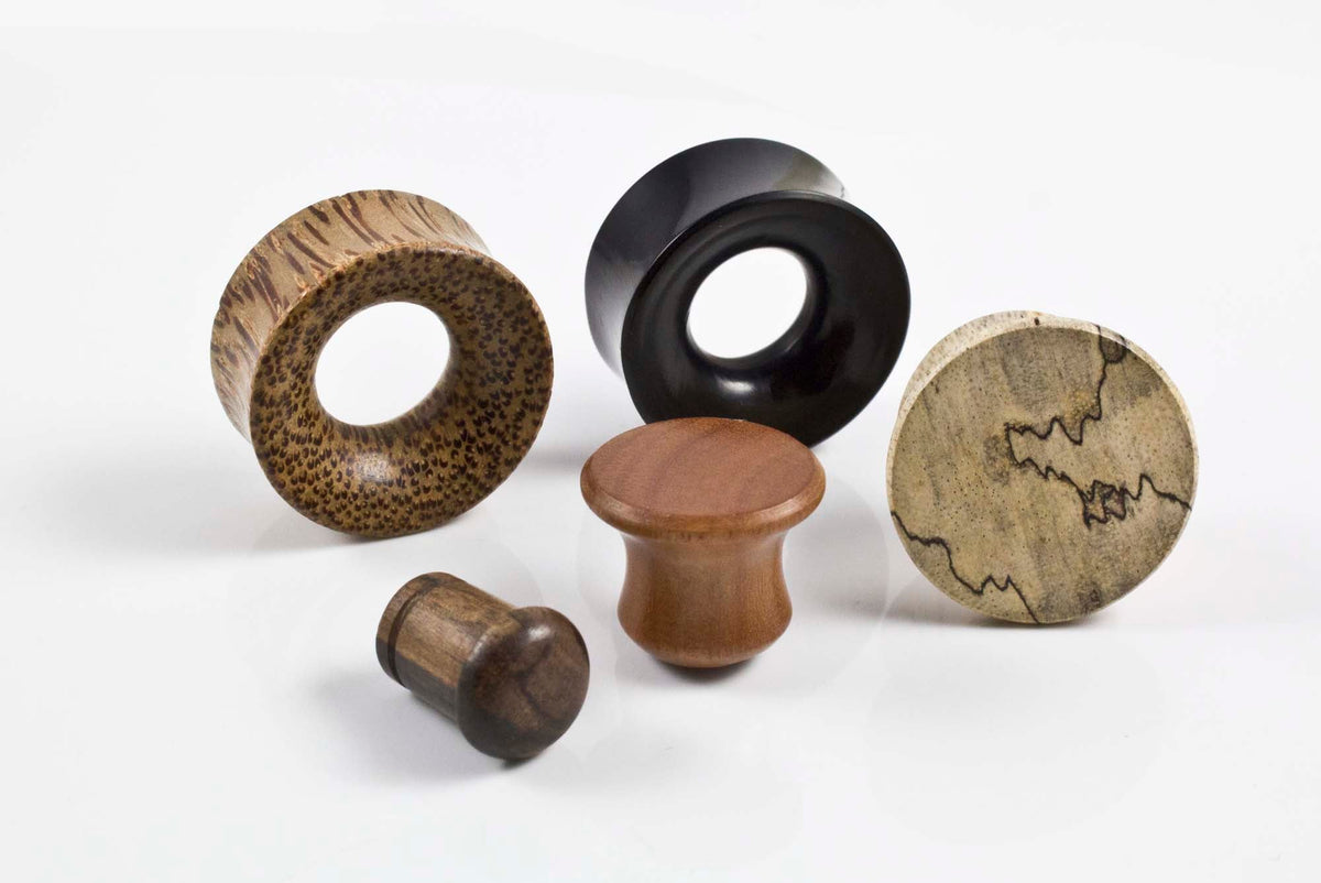 wooden plugs featuring single flare, double flare tunnels, and mayan flare designs
