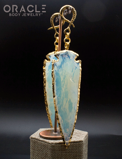 a hanging view of the opalite arrowhead jewelry showing a warm glow 