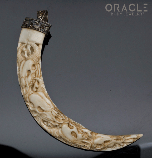 Boar's Tusk Pendant with Carved Buffalo Skulls and Silver Filigree